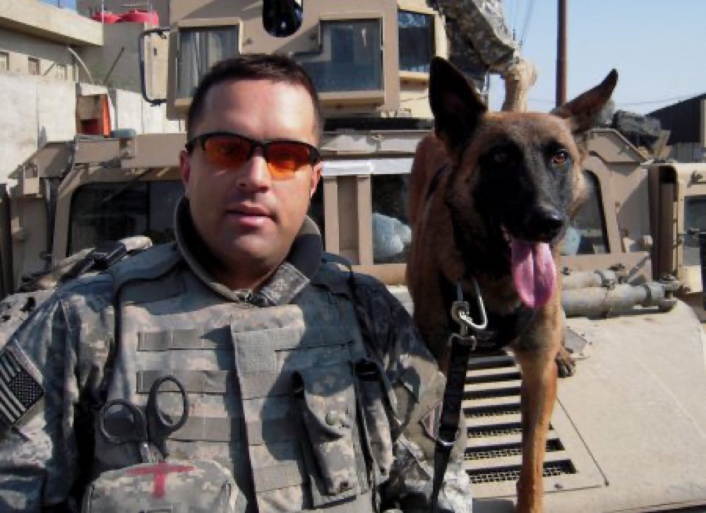 Ryky, a military working dog, deployed in the field with his handler